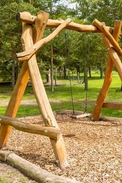 Rustic Wooden Playground Swing in a Forest Setting Stock Photos