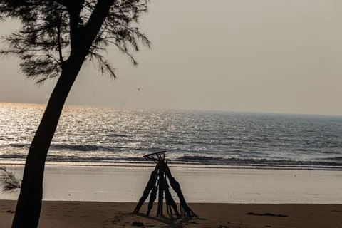 Rustic wooden pole structure for drying nets on empty seashore Stock Photos