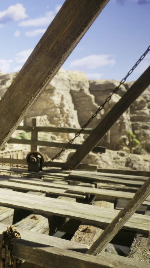 Rustic wooden pulley system nestled in a rocky canyon landscape Stock Footage 331832346