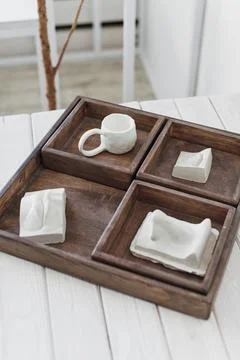 Rustic Wooden Serving Tray with White Ceramicware on a Bright Interior Setup Stock Photos