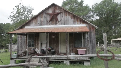 Rustic Wooden Shack with Lone Star and Barbed Wire Fence Stock Footage 345279337