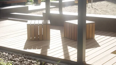 Rustic wooden sitting blocks rest on durable timber decking Vídeos de archivo 330571446