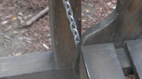 A Rustic Wooden Structure Featuring a Chain Attachment, Perfectly Positioned in Stockbeeldmateriaal 280997054