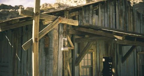Rustic wooden structure with lantern in an old western town setting 库存插图