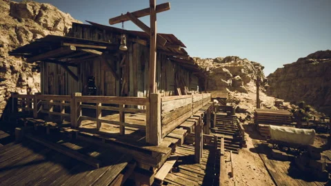 A rustic wooden structure set against rocky hills in a desert landscape Vídeos de archivo 327195699