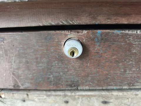 Rustic Wooden Surface with Embedded Cylinder Lock for Security Stock-Fotos