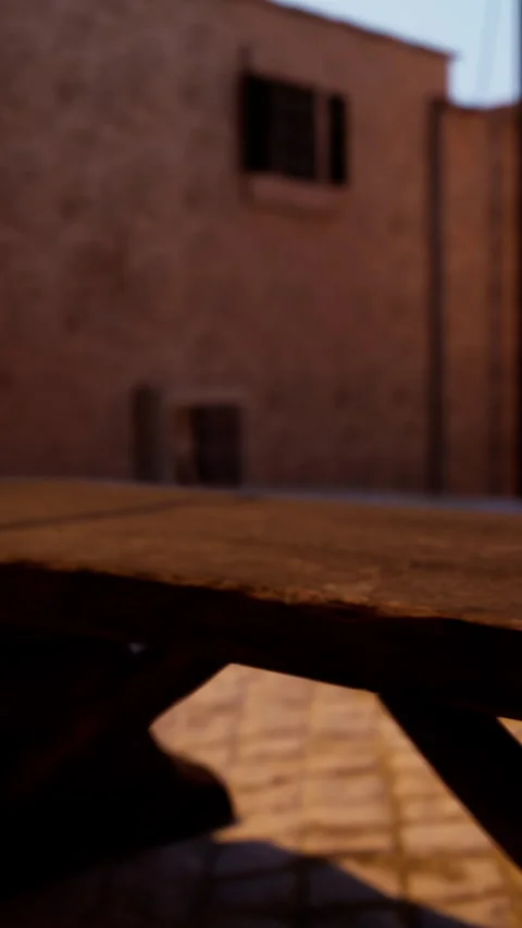 Rustic wooden table in evening light with walls and shadows around it Stock Footage 340870691
