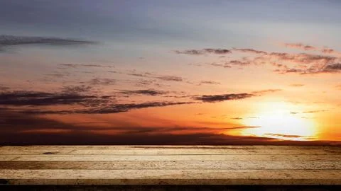 Rustic wooden table surface with sunset scene background. Mockup, template,.. Stock Photos