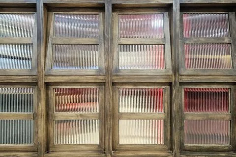 Rustic wooden window frames with textured glass panes. Stock Photos