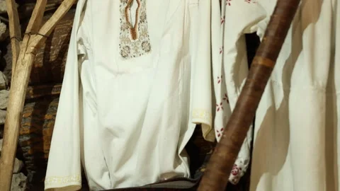 Rustic workshop showcasing handcrafted linen shirts with floral details Stock Footage 337938786