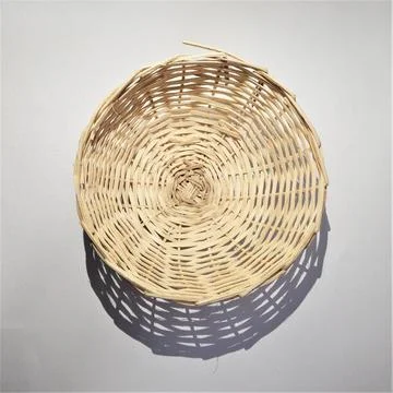 Rustic Woven Basket with Intricate Pattern and Shadow Play Stock Photos