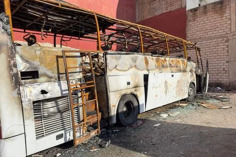 Rustic wreckage of a bus abandoned in the scrap yard Stock Photos