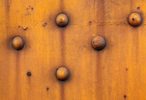 Rustic yellow wall with rivets Stock Photos