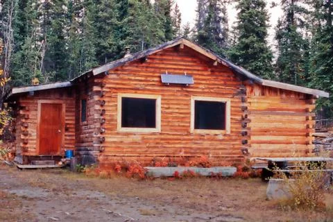 Rustic yukon canada log cabin outside solar panel Stock Photos