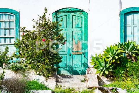 Rustical abandoned old house with weathered green door in Beautiful village o Stock Photos