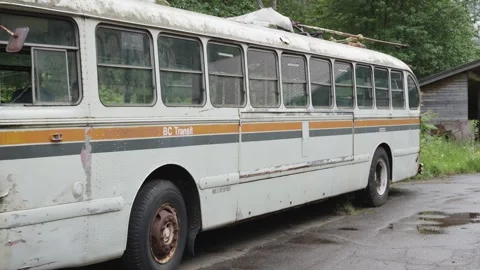 A rusting abandoned bus stands in a mystical town,historical, retro backgrounds. Stock Footage 250193986