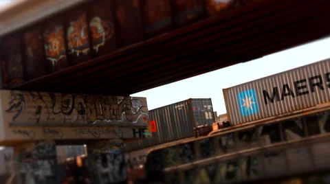 Rusting Graffiti covered overpass and Train Bridge as freight train passes Stock Footage 58239255