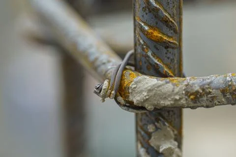 The rusting handle and rope has been bent down to expose a rusty looking wire Photos