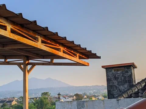 Rusting metal canopy structure with scenic mountain and residential view Stock Photos