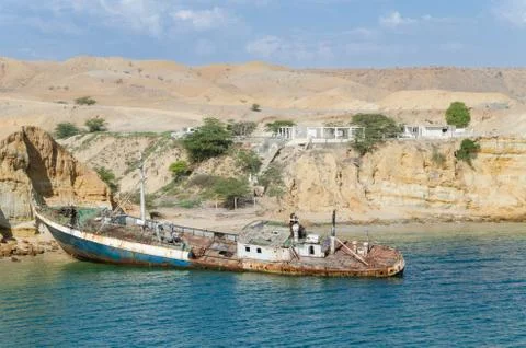 Rusting ship wreck stranded at beach of Angola's Namib coast Stock Photos
