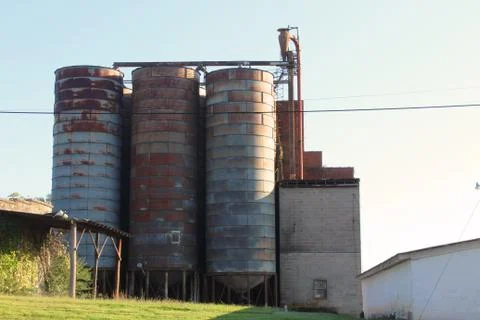 Rusting silos at an old milling facility Stock Photos
