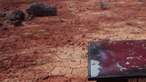 Rusting Table Stands Alone on Dusty, Cracked Earth Under a Bright Sun Stock Footage 348494296