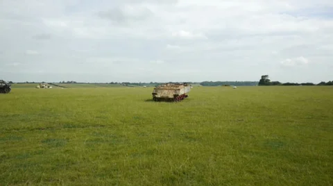 Rusting tank hull lying in a field Stock Footage 37396462