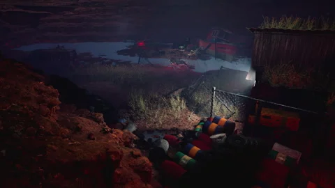 Rusting vehicles and debris in a desolate desert landscape at night Stock Footage 318321851