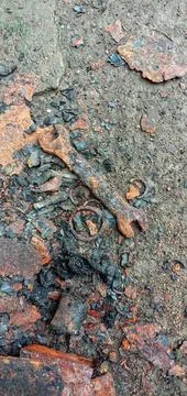 A rusty 10-12 size ring wrench on the cement floor Photos