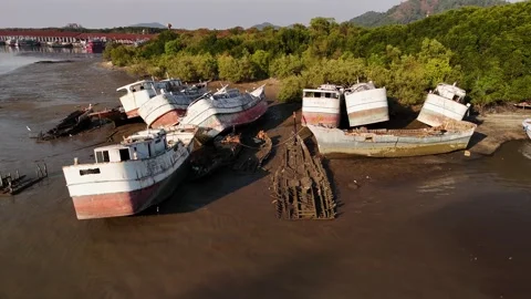 Rusty abandoned maritime ship stranded on seabed during low tide near phuket Stock Footage 313151418