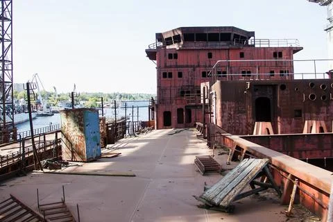 Rusty, abandoned ship under construction, unfinished ship at the factory. Stock Photos