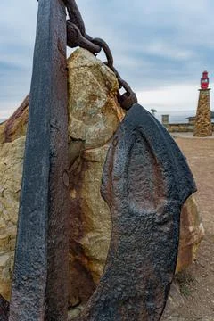 Rusty anchor with chain foreground Stock Photos