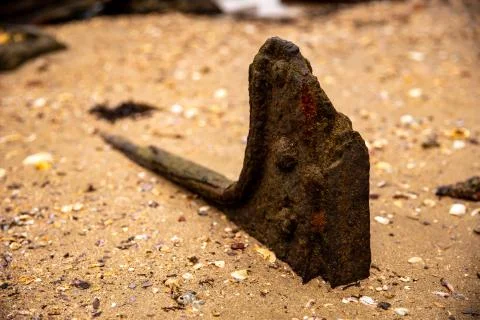 A Rusty Anchor on a Sandy Beach Stock Photos