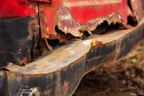 Rusty and bent back of the van. Old rusty bent rear bumper of a car half Stock Photos