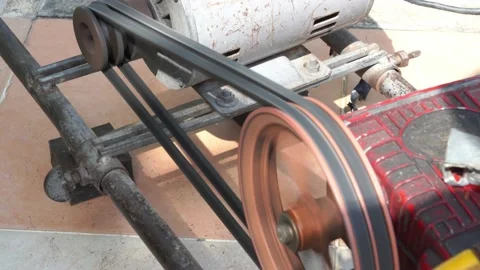 Rusty and old water pump motor working, Rotating pulley and belt on air pump  Stock Footage 130893119