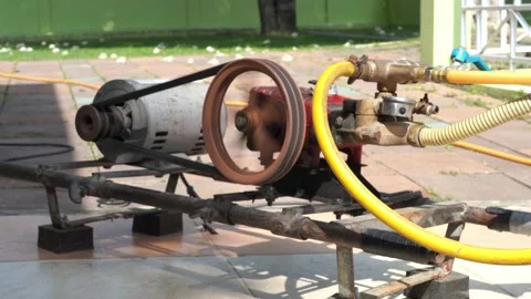 Rusty and old water pump motor working, Rotating pulley and belt on air pump  Stock Footage 130893157