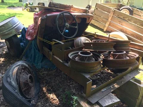 Rusty antique car in backyard Stock Photos