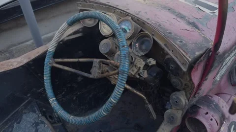Rusty Antique Car Interior featuring a Vintage Steering Wheel with historical Stock Footage 305278777