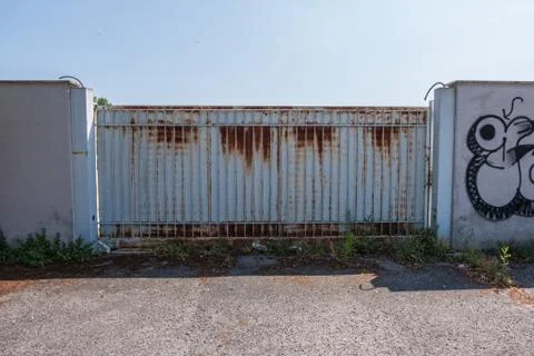 Rusty automatic metallic gate. Stock Photos