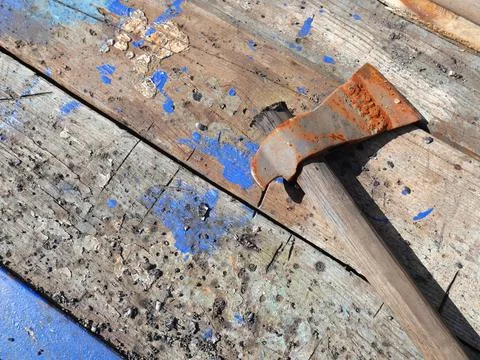 A rusty axe is lying on the table. The blade is clearly visible Stock Photos