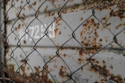 Rusty background through metal mesh Stock Photos
