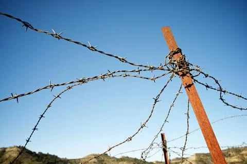 Rusty barbed wire fence Stock Photos