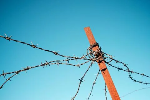 Rusty barbed wire fence Stock Photos