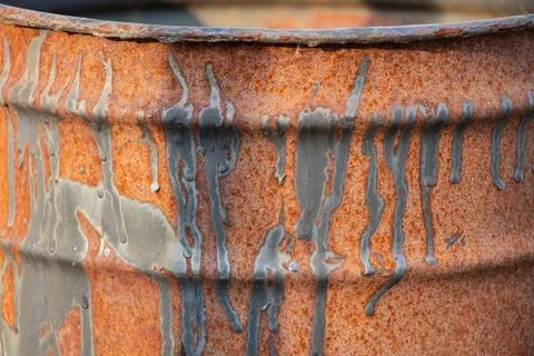 Rusty barrel with black paint drips as background close-up, rusty Stock Photos