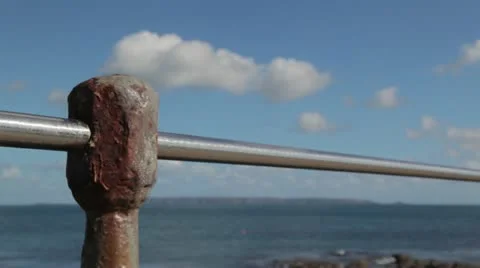 Rusty, battered railing overlooking the sea and islands Stock Footage 12209592