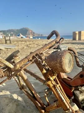 Rusty beach motorcycle Stock Photos