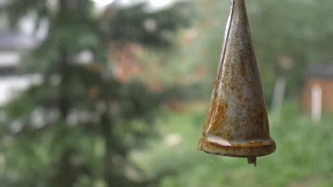 Rusty Bell Hanging Outside in Calming Rainstorm Stock Footage