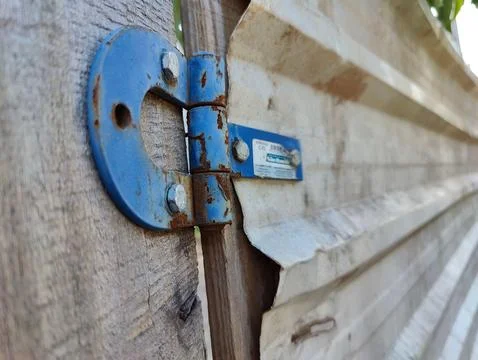 Rusty blue gate hinge Stock Photos