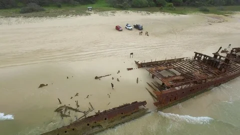 Rusty boat and mountains on beach Stock Footage 79704238