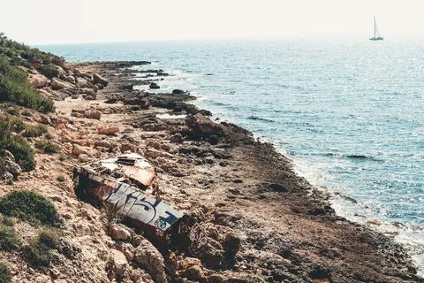 Rusty boat and party stranded on the beach Stock Photos